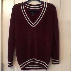 Maroon sweater with stripes.